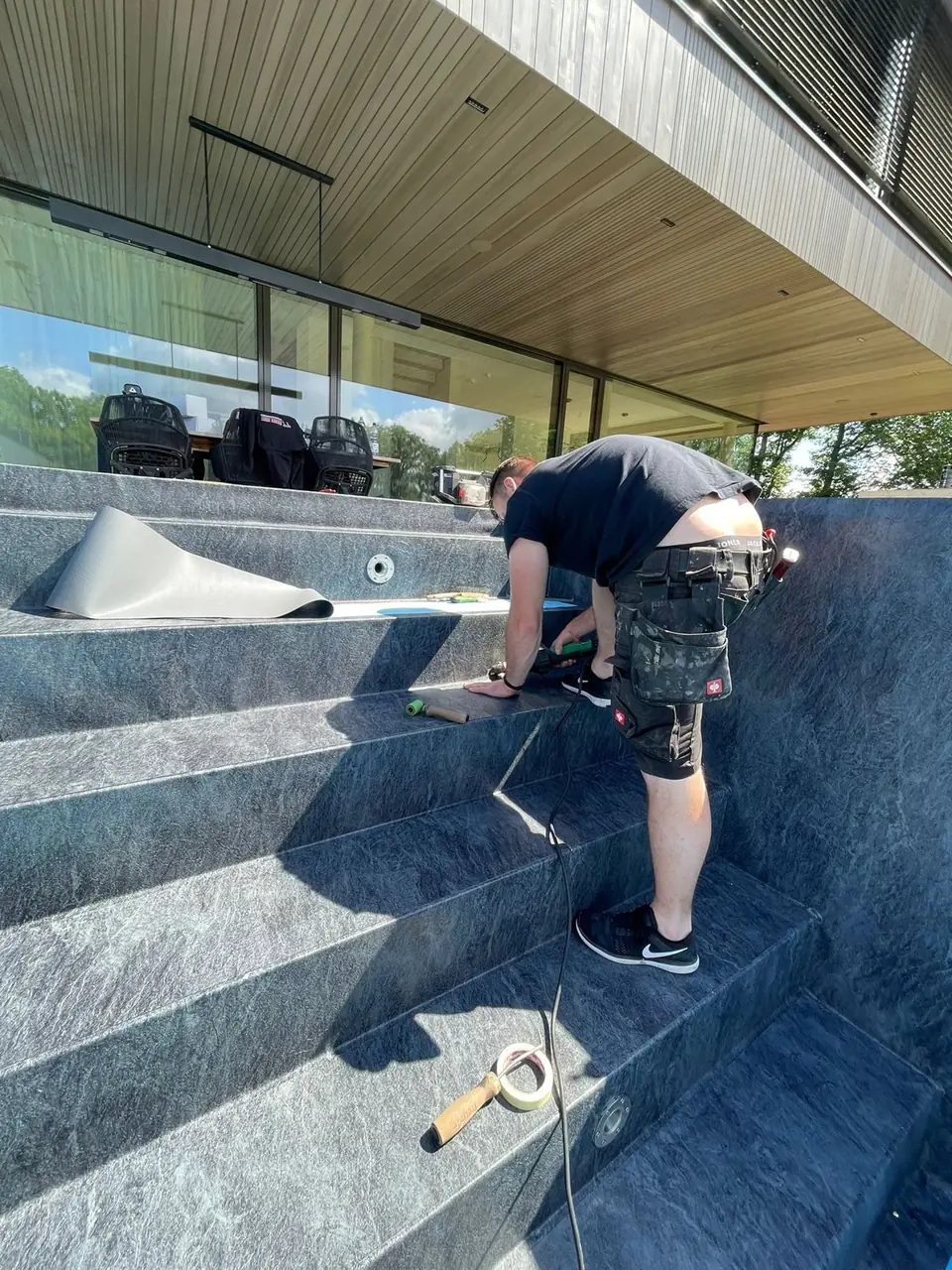 Verarbeitung der Poolfolie durch einen Mitarbeiter